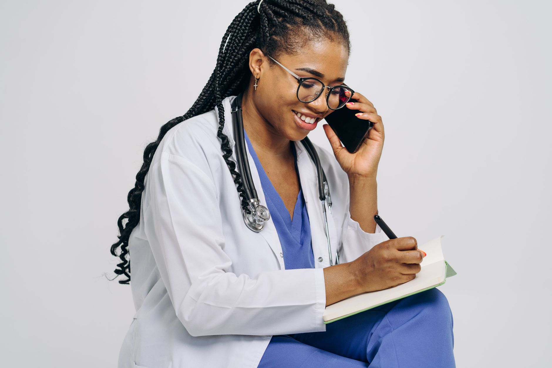 GP clinician on telephone triage call, reflecting NHS primary care crisis pressures on consultation access