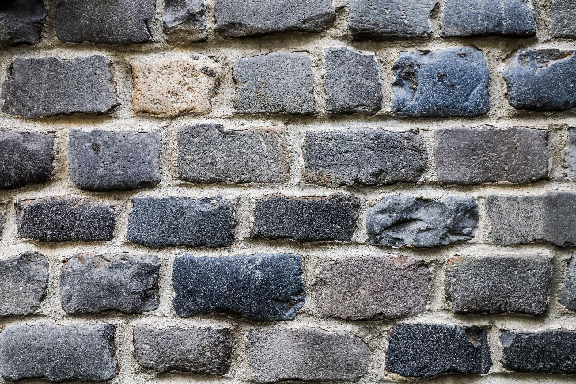 Stonemason repairing historic stonework with lime mortar, the kind of specialist craft needed to rescue listed buildings at risk England